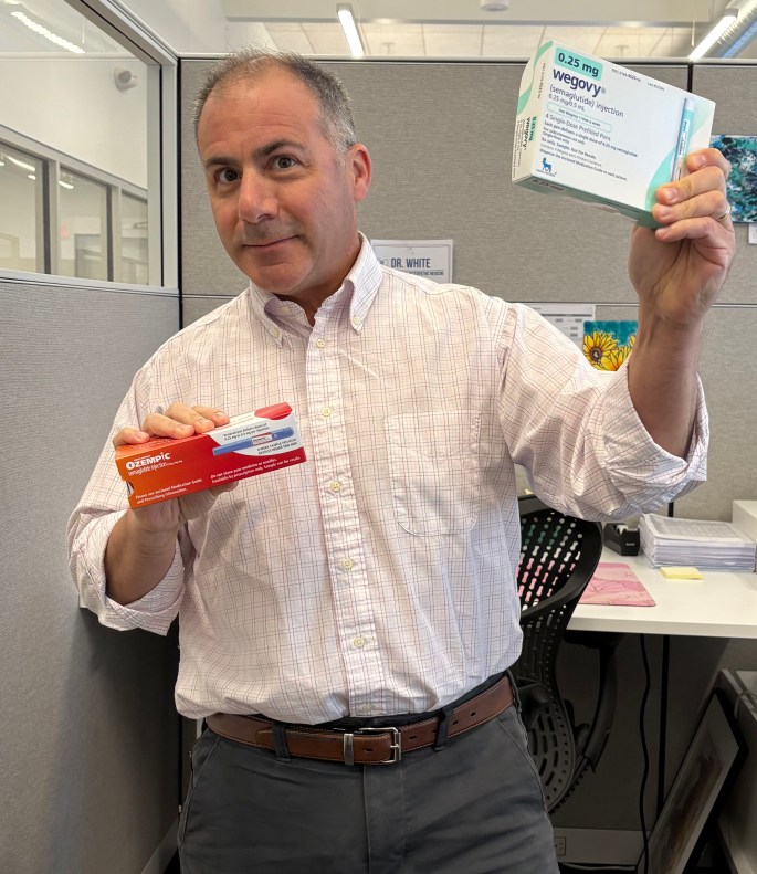 Doctor holding ozempic and wegovy